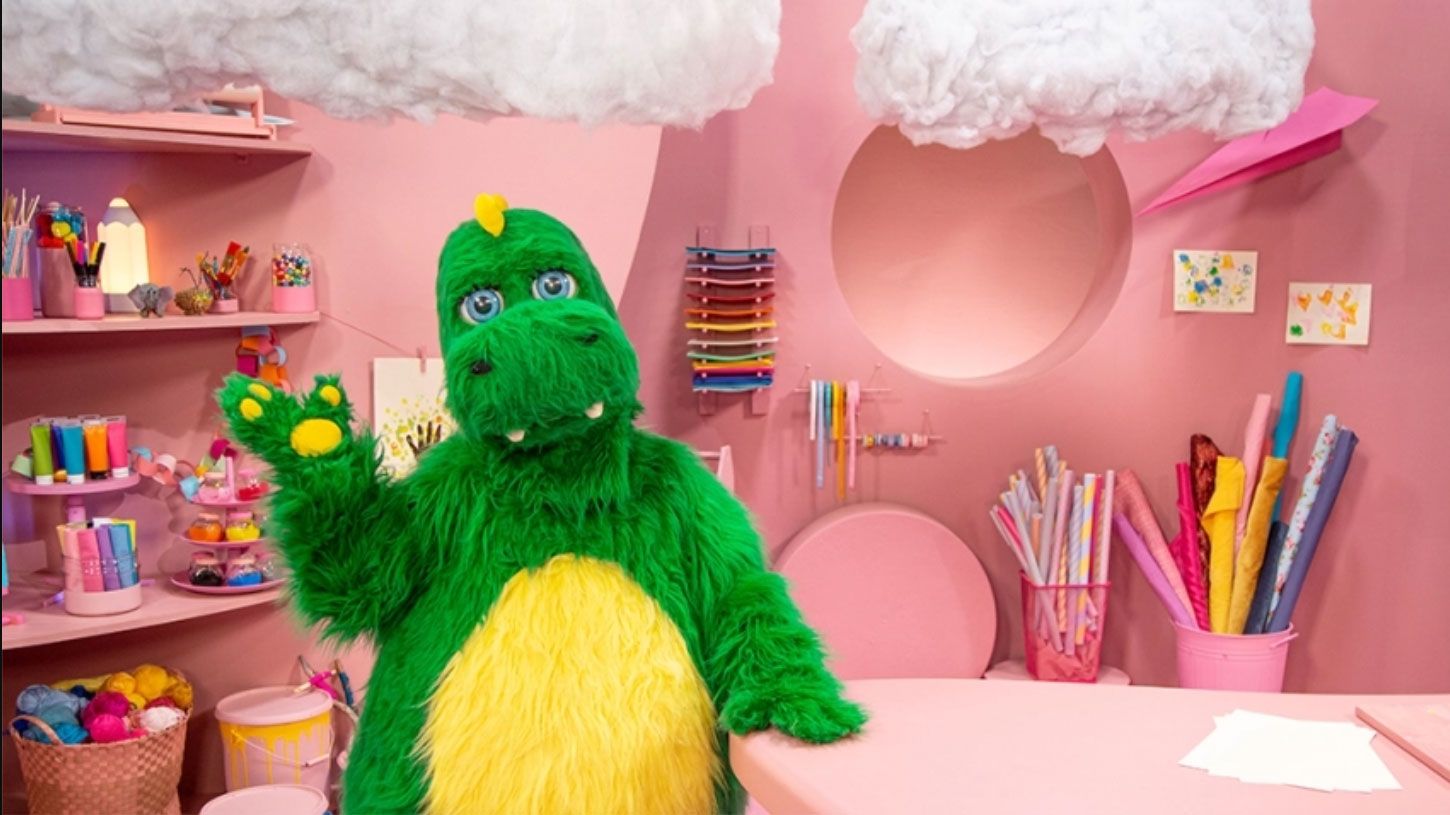 The green Bolibompa dragon in a pink children's TV studio