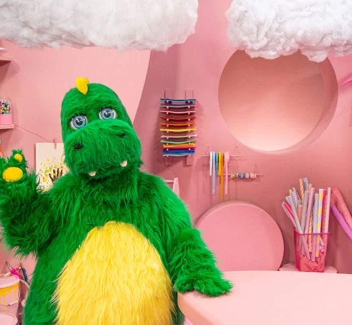 The green Bolibompa dragon in a pink children's TV studio